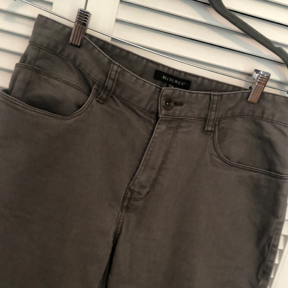 Grey “jeans” or chinos.